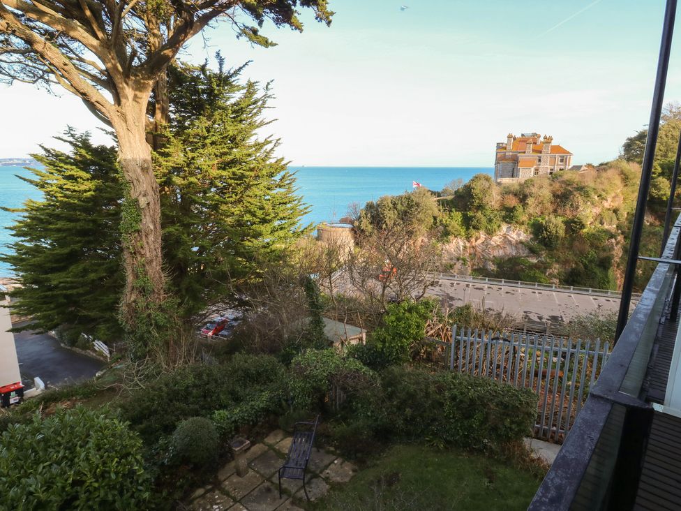 An outdoor view of the sea and a house at 20 Heath Court in Brixham