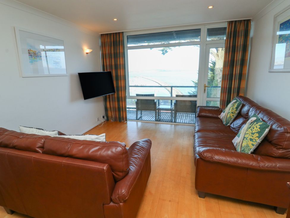 A living room with two sofas and a television at 20 Heath Court in Brixham