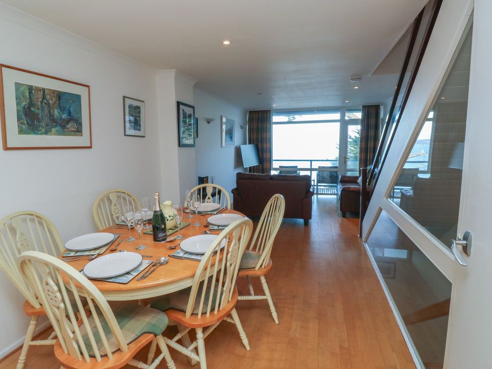 A dining area with a table and chairs at 20 Heath Court in Brixham