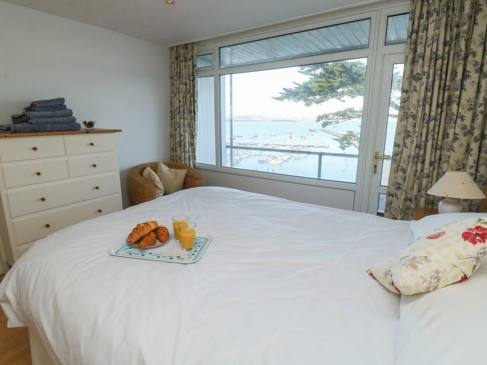 A bedroom with a bed and dresser at 20 Heath Court in Brixham