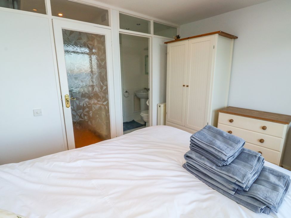 A bedroom with towels on the bed at 20 Heath Court in Brixham
