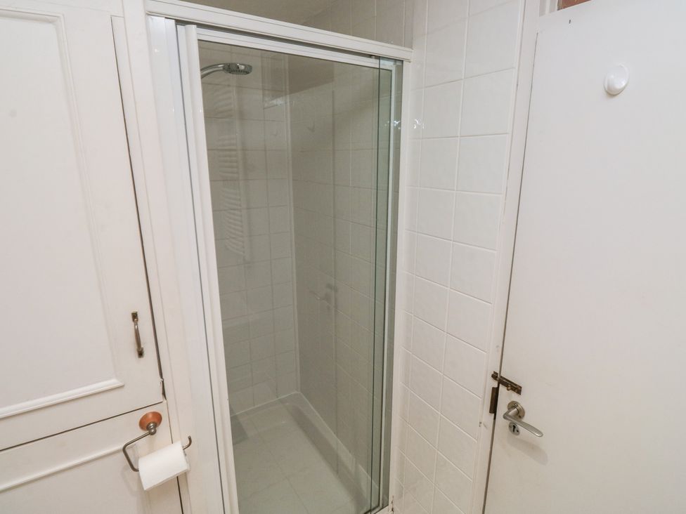 A shower enclosed in glass with a door in a bathroom at 20 Heath Court in Brixham