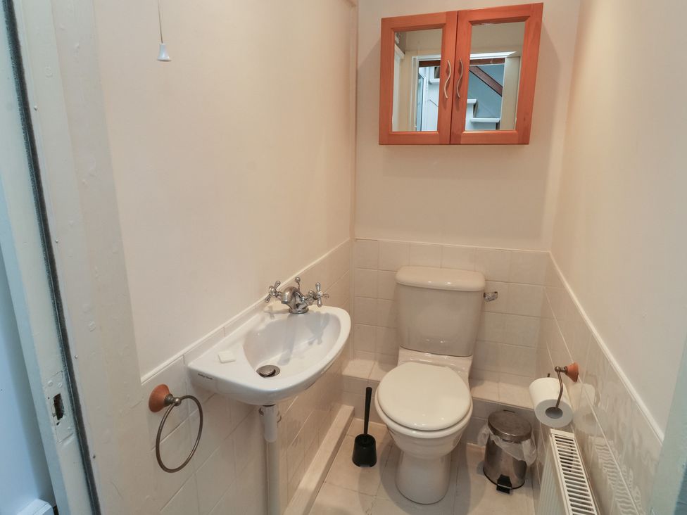 A bathroom with toilet and washbasin at 20 Heath Court in Brixham