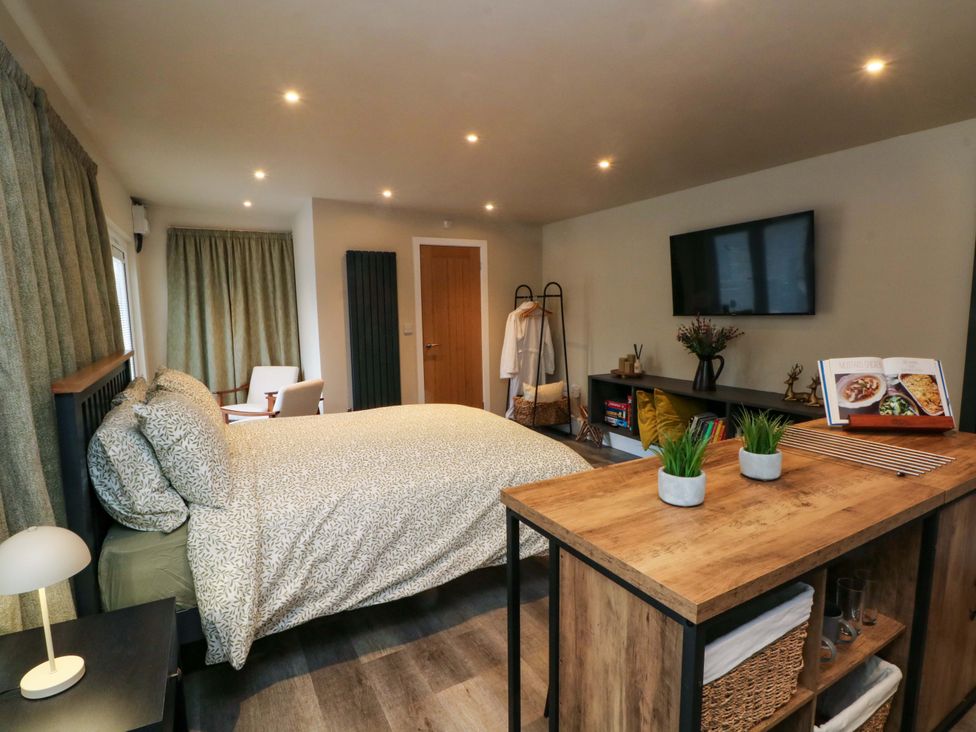 A bedroom with a bed and television at Cabin in 