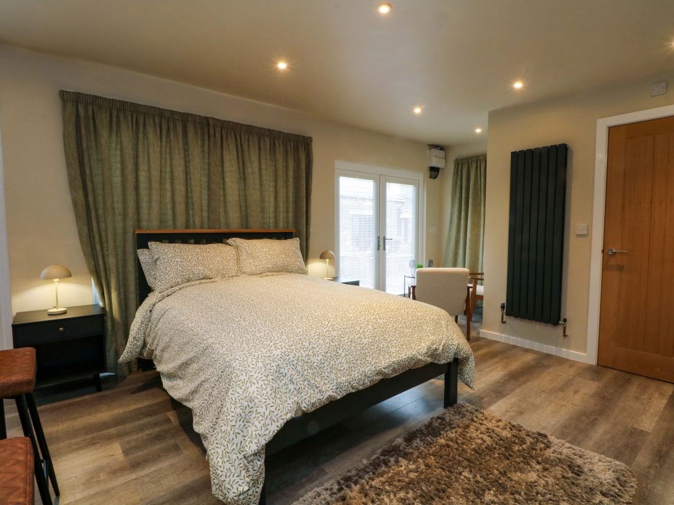 A bedroom with a bed and nightstand at the Cabin