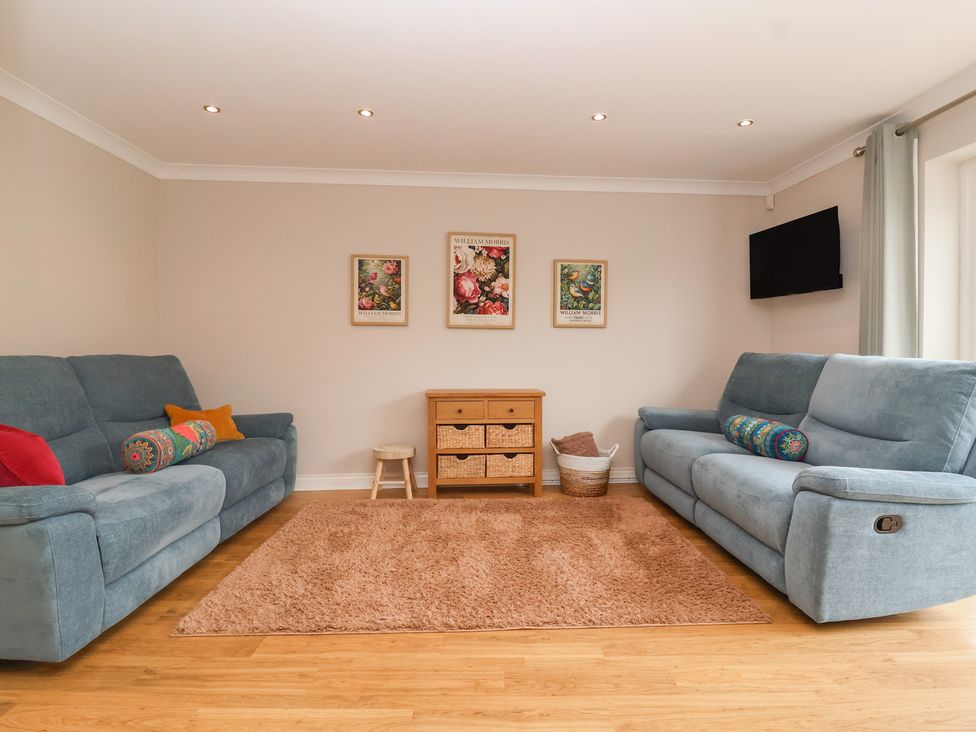 A living room with sofas and a chest of drawers at 122 Longridge Way Weston-Super-Mare