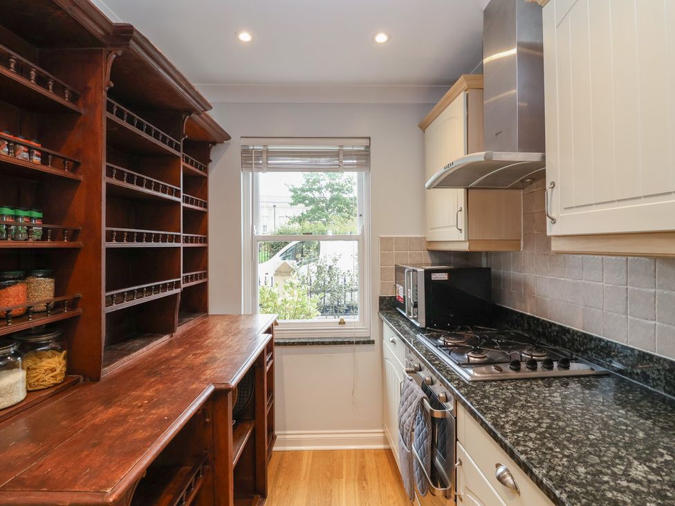 A kitchen with shelves and appliances at 122 Longridge Way Weston-Super-Mare