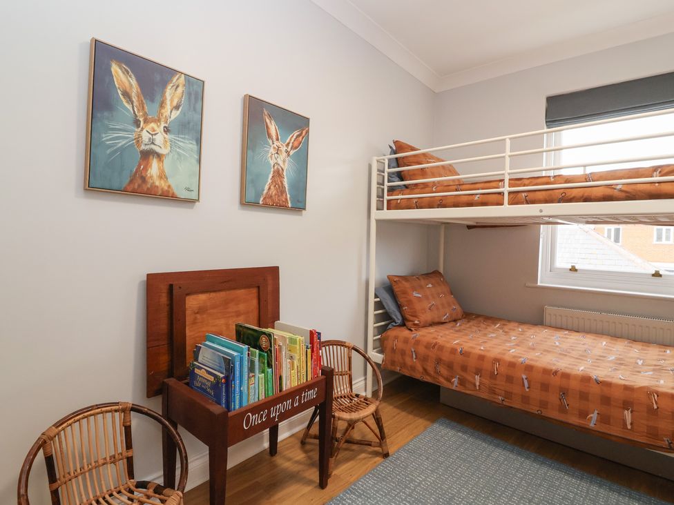 A bedroom with a bunk bed and a bookshelf at 122 Longridge Way, Weston-Super-Mare