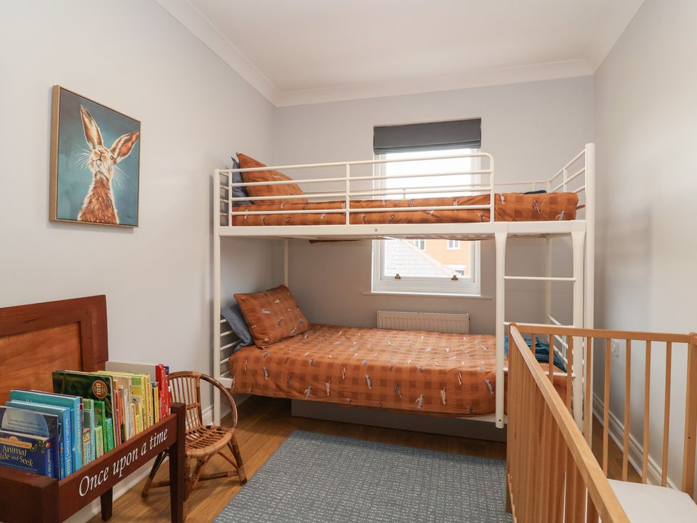 A bedroom with bunk bed and baby crib at 122 Longridge Way Weston-Super-Mare