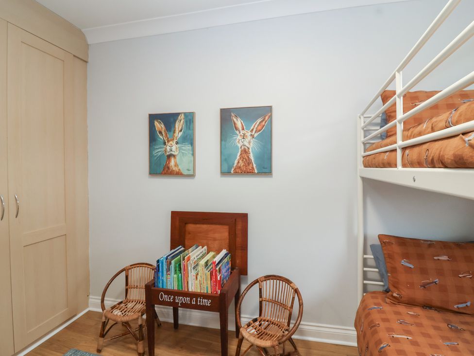 A bedroom with a bunk bed and bookshelf at 122 Longridge Way Weston-Super-Mare