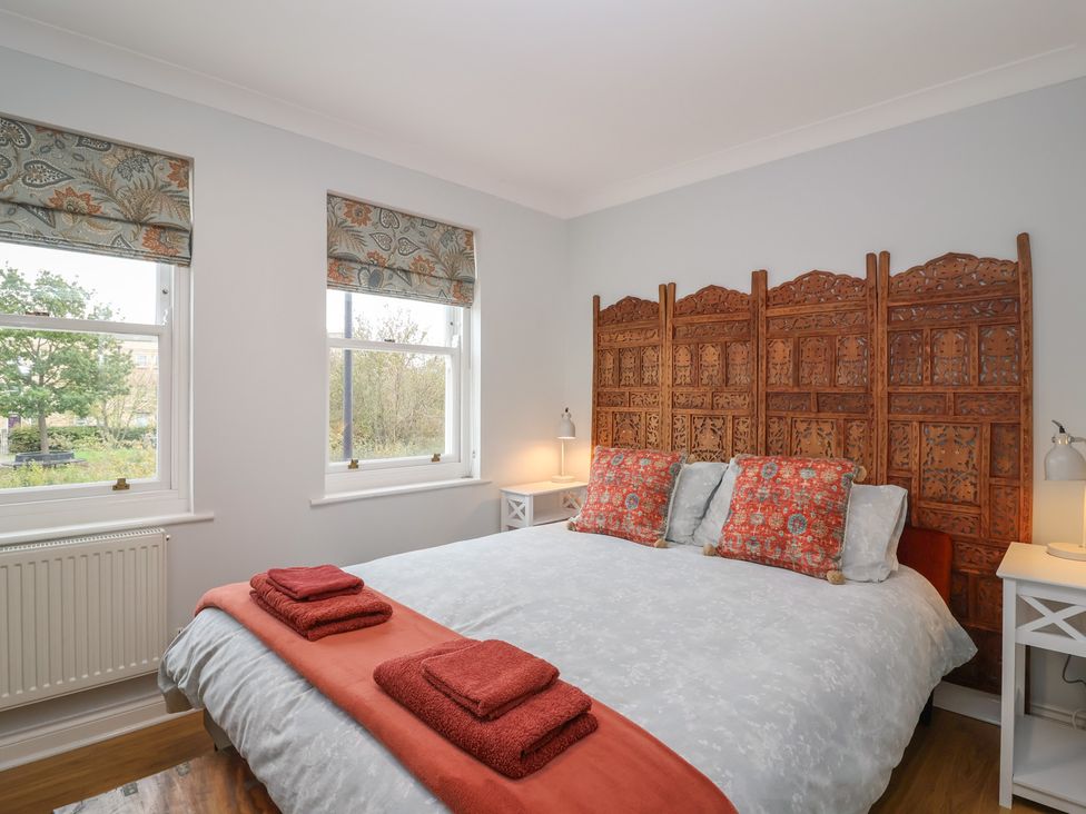 A bedroom with a bed and bedside tables at 122 Longridge Way Weston-Super-Mare