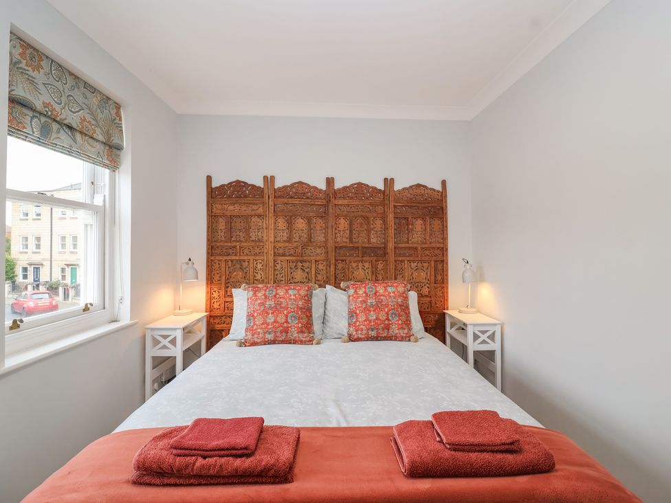 A bedroom with a bed and decorative panel at 122 Longridge Way in Weston-Super-Mare