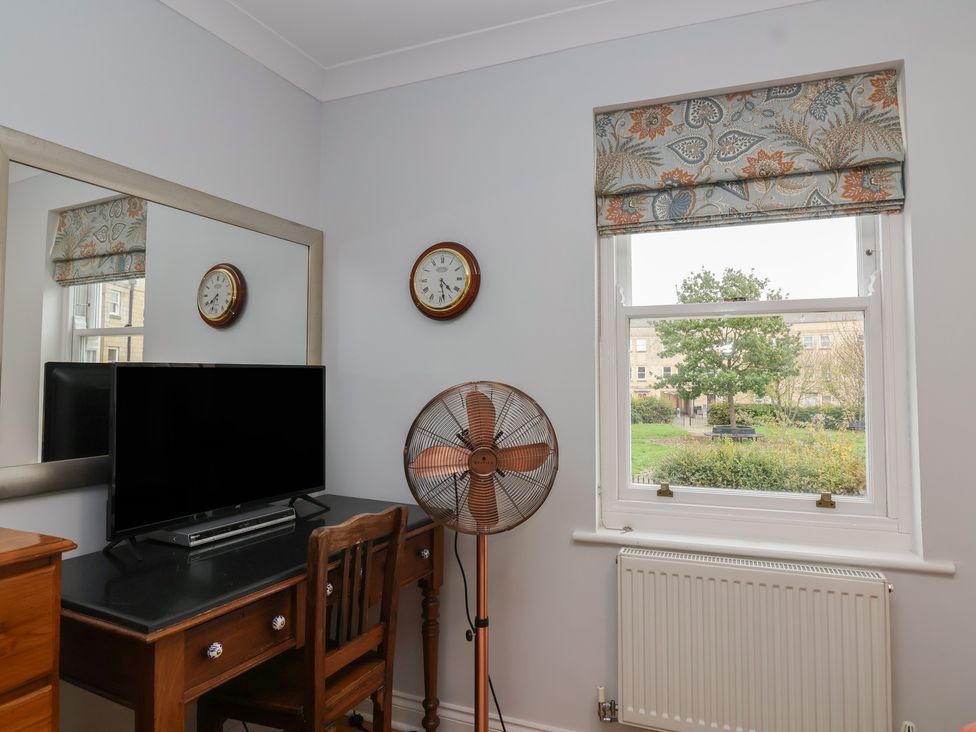 A bedroom with a desk and television at 122 Longridge Way Weston-Super-Mare