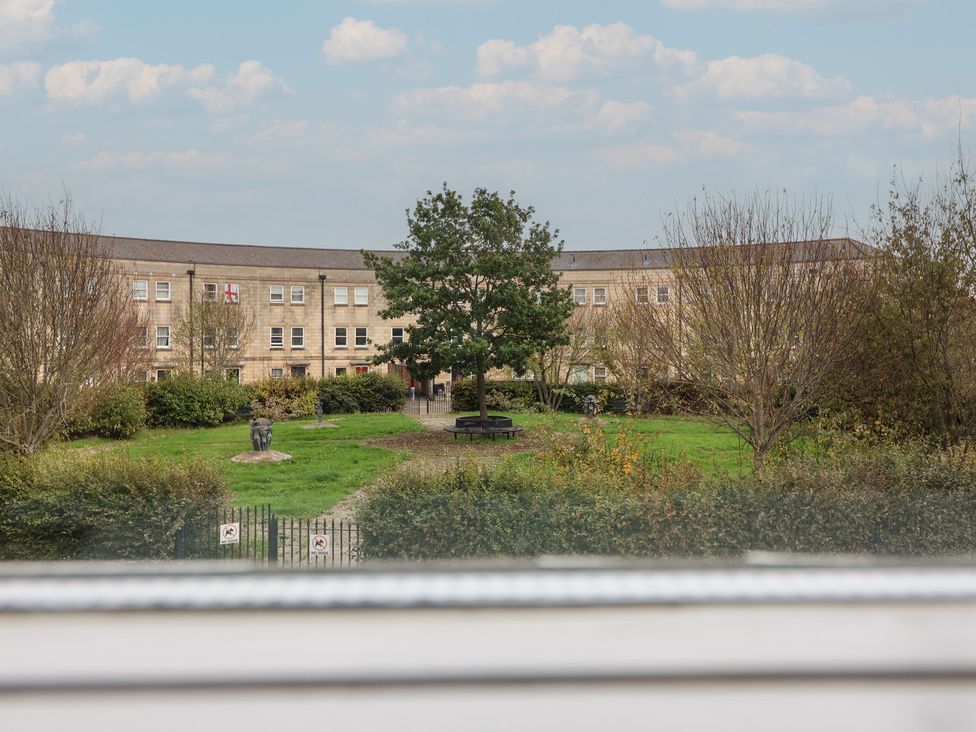 A park with benches and a statue outside a building at 122 Longridge Way Weston-Super-Mare