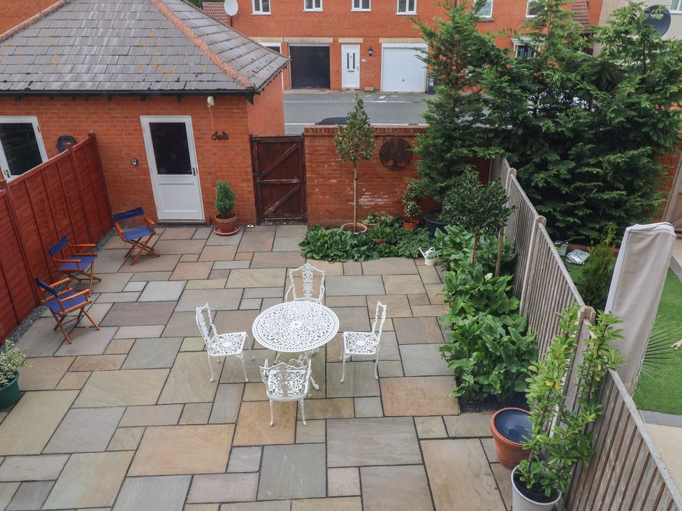 A garden with a patio, table and chairs at 122 Longridge Way Weston-Super-Mare