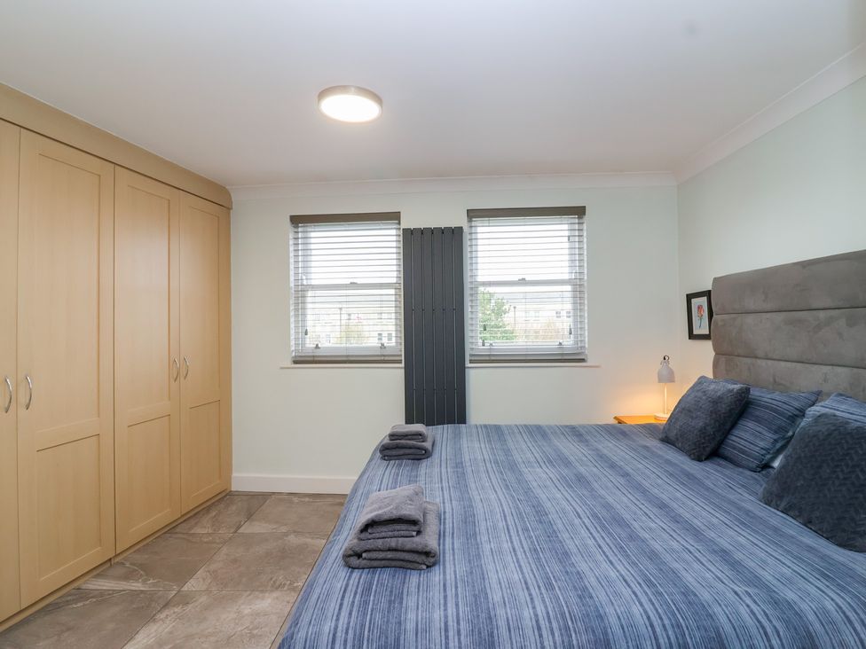 A bedroom with a bed and wardrobe at 122 Longridge Way Weston-Super-Mare