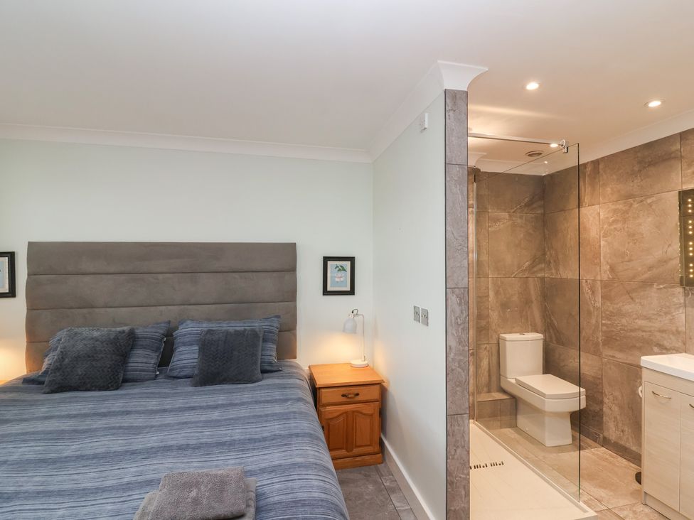A bedroom with a bed and attached bathroom at 122 Longridge Way Weston-Super-Mare