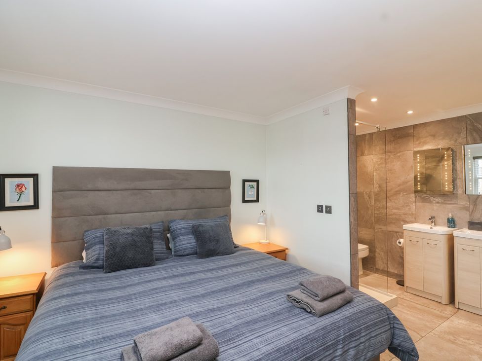 A bedroom with a bed and attached bathroom at 122 Longridge Way Weston-Super-Mare