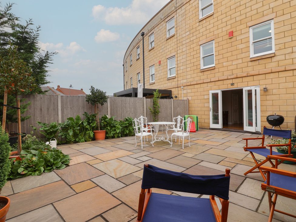 A garden with paving stones and seating at 122 Longridge Way in Weston-Super-Mare