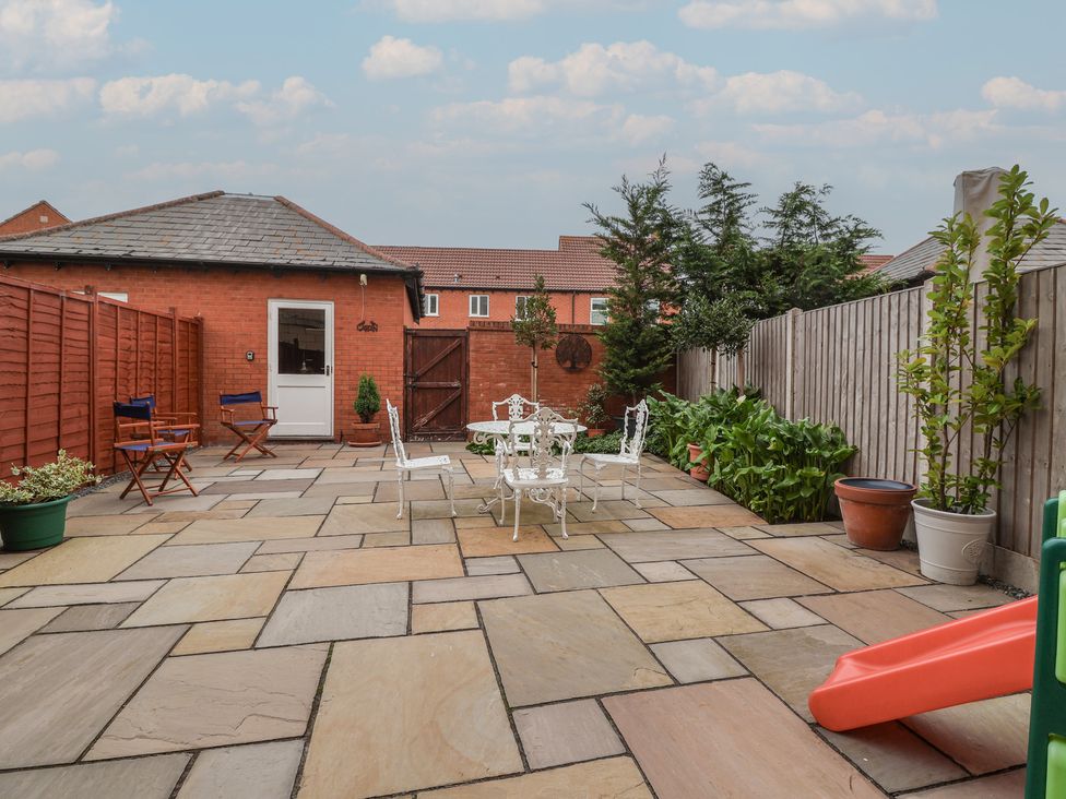 A garden with chairs and a table on the patio at 122 Longridge Way Weston-Super-Mare