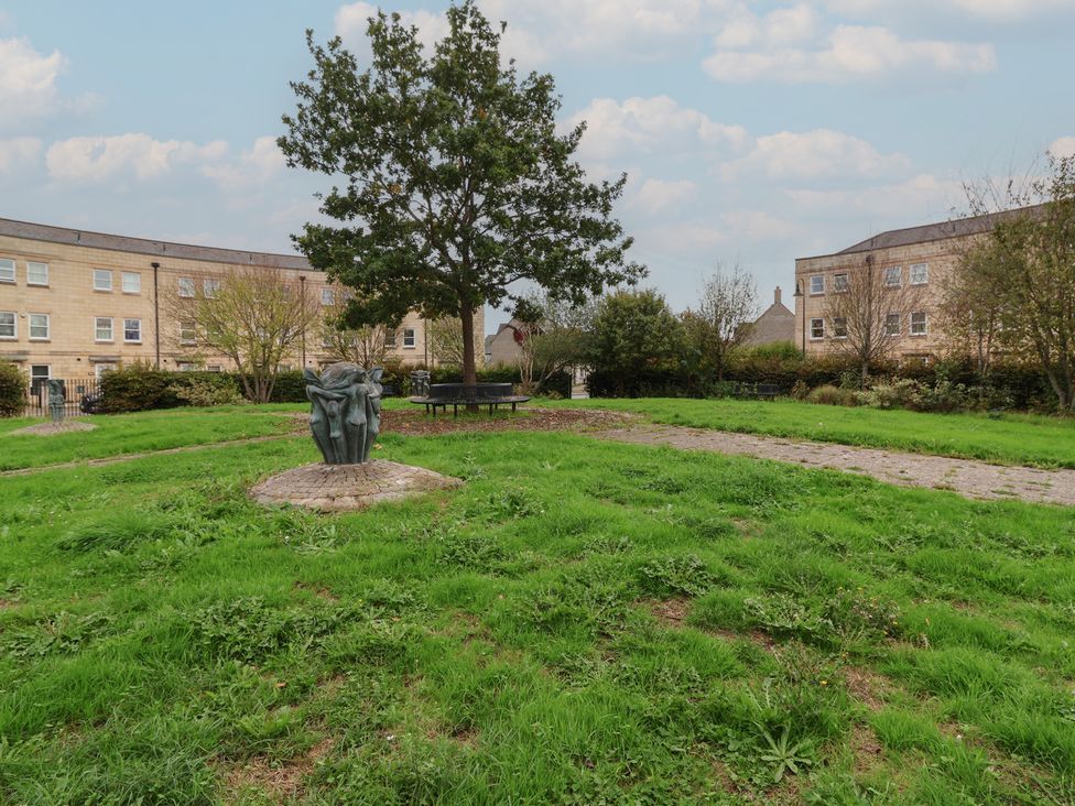 A park with a sculpture and bench near buildings at 122 Longridge Way Weston-Super-Mare