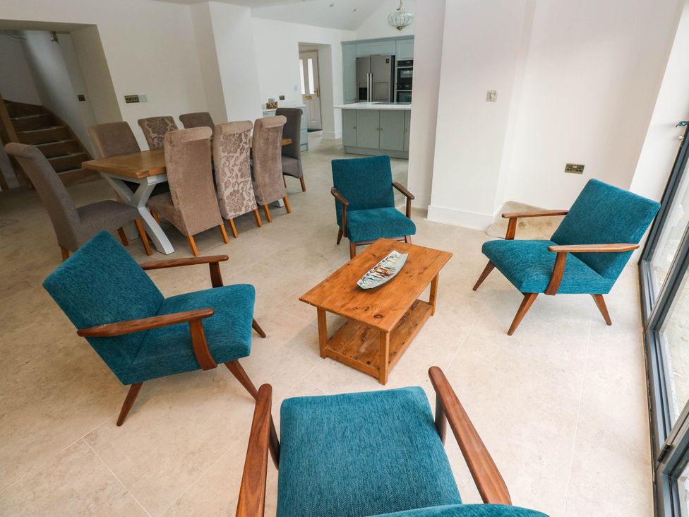 A dining room with armchairs and a table at Hawthorns 