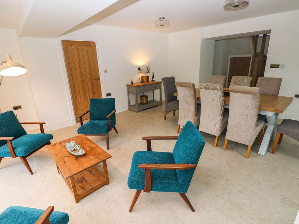 A dining room with a table and chairs at Hawthorns