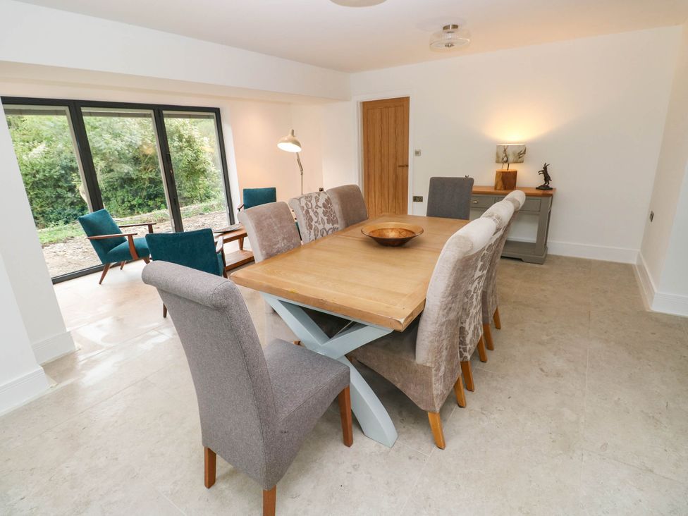 A dining room with a table and chairs at Hawthorns 