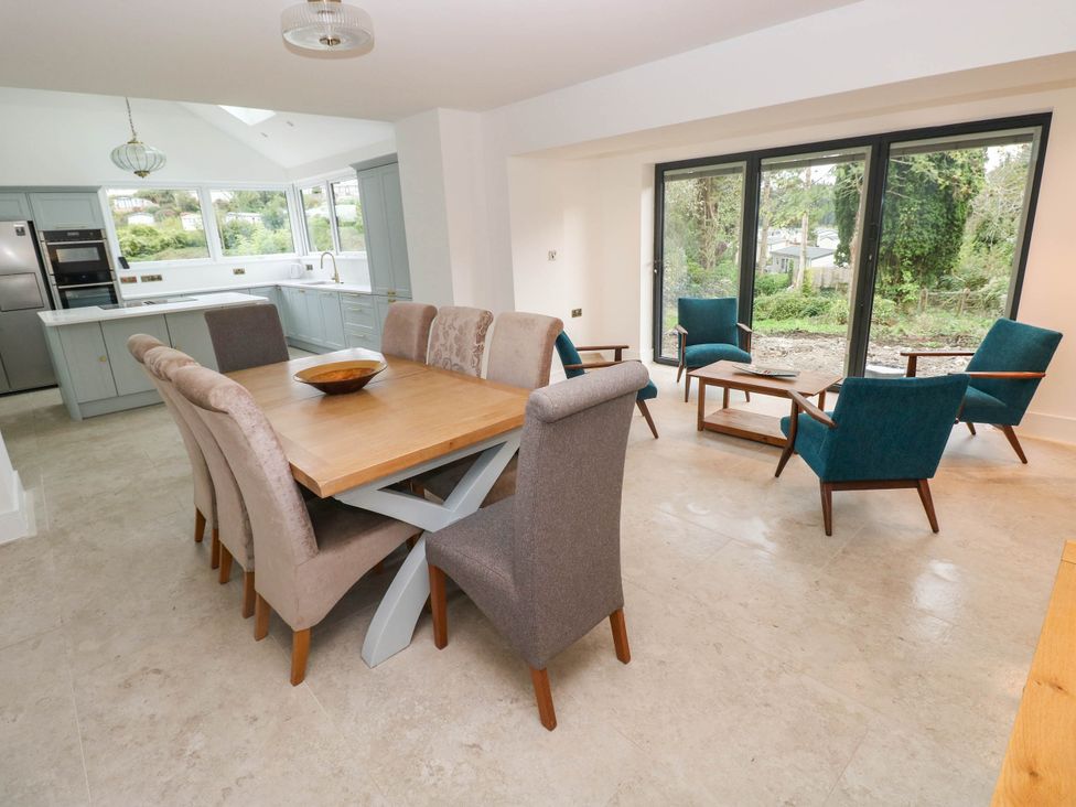 A dining room with a table and chairs at Hawthorns