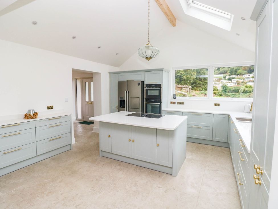 A kitchen with an island and appliances at Hawthorns in 