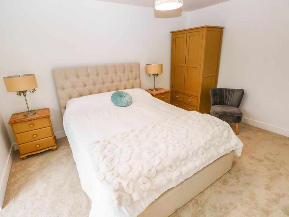 A bedroom with a bed and wardrobe at Hawthorns