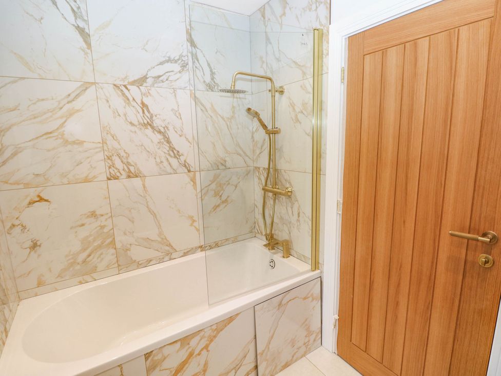 A bathroom with a bathtub and shower at Hawthorns