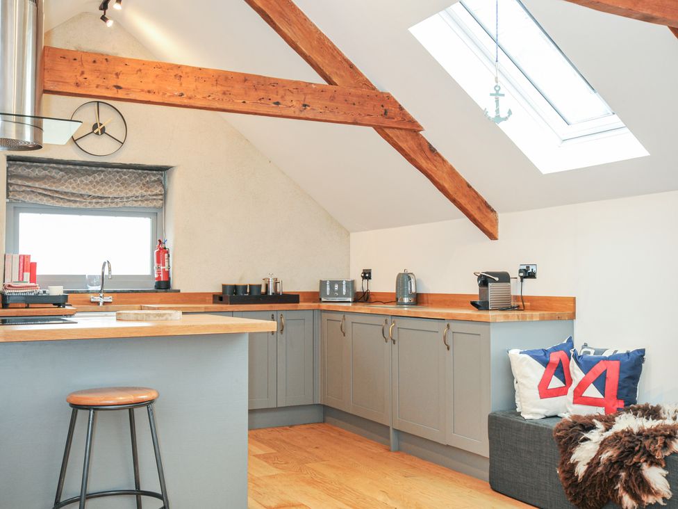 A kitchen with wooden beams and a skylight at The Dairy in 