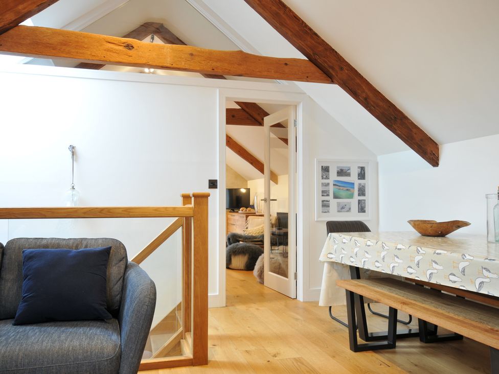 A living room with a table and chairs at The Dairy in 