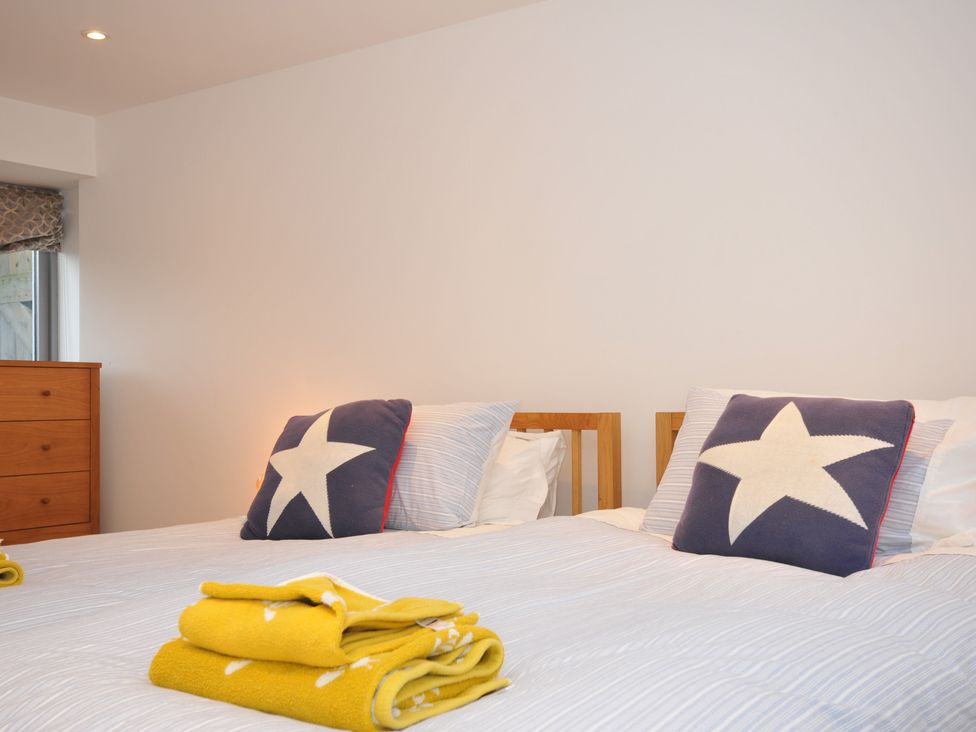 A bedroom with two single beds and a chest of drawers at The Dairy in 