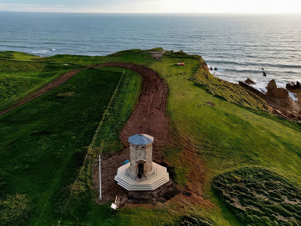 An aerial view of a gazebo on a cliff overlooking the ocean at The Dairy in Bridgerule