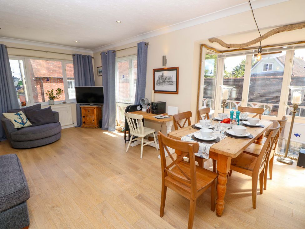 A living room with a sofa and dining table at Riverview in Hamble