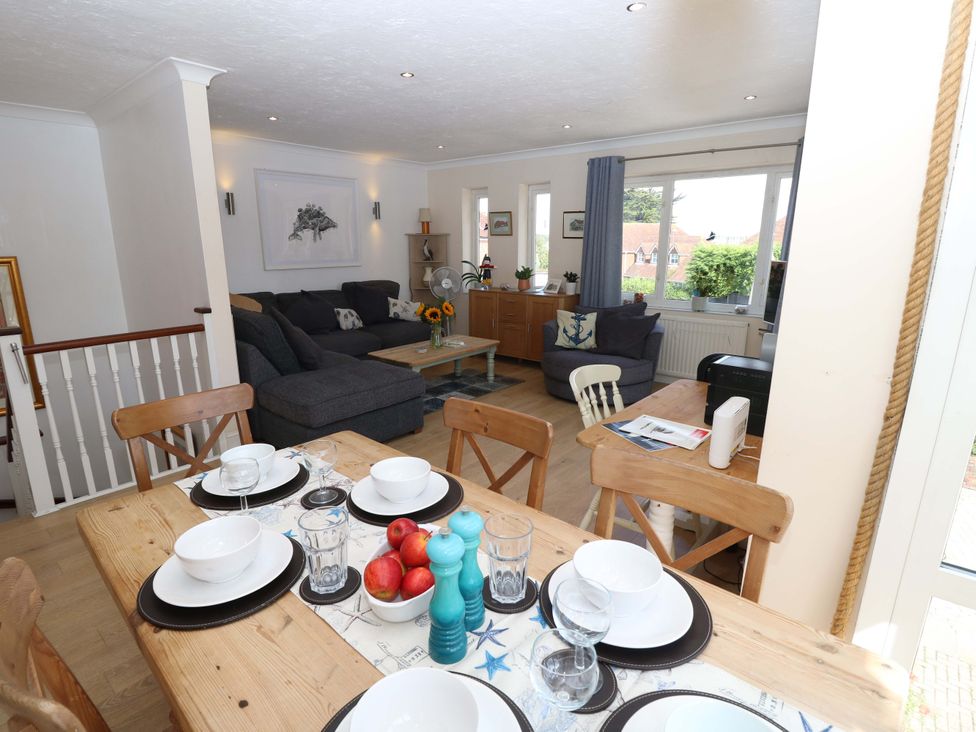 A living room with a sofa and dining area at Riverview in Hamble