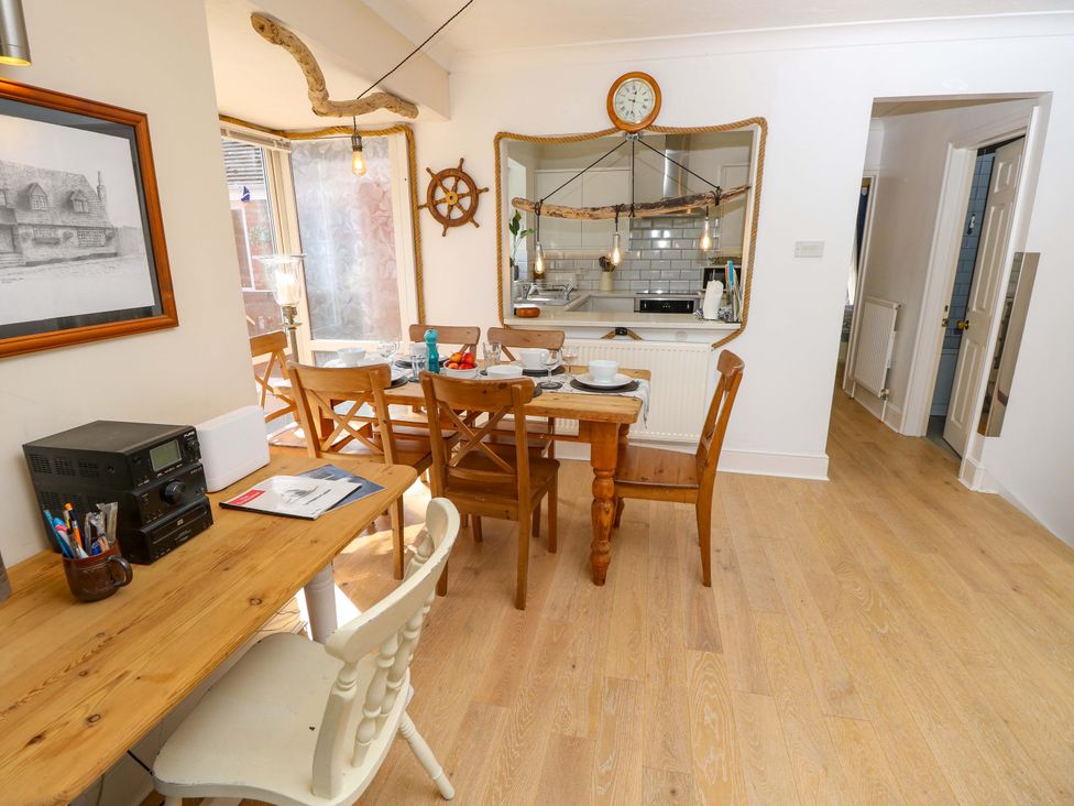 A dining room with a table and chairs at Riverview in Hamble