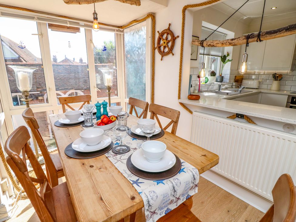 A dining room with a table set for dinner at Riverview in Hamble