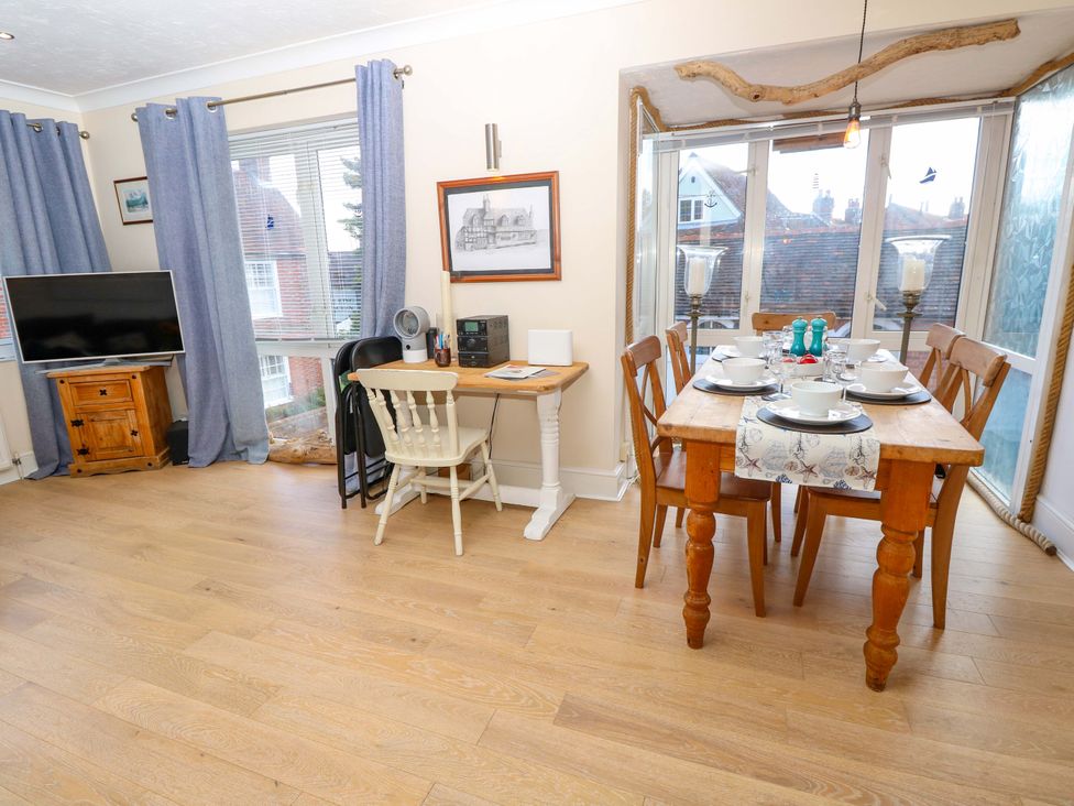 A living room with a dining area and a television at Riverview in Hamble