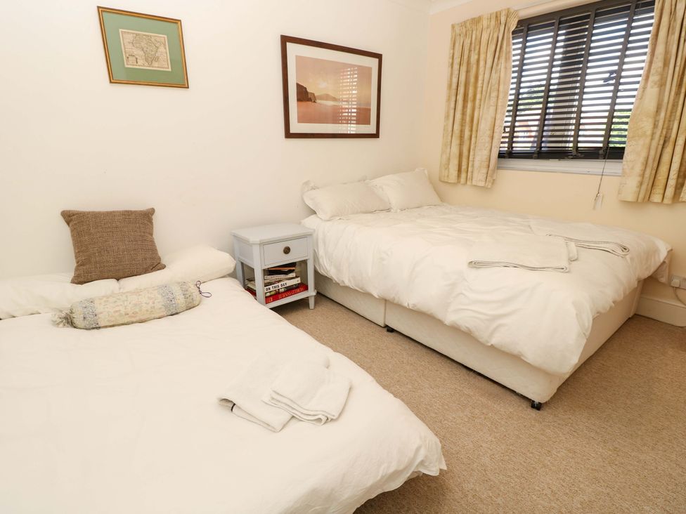 A bedroom with two beds and a bedside table at Riverview in Hamble