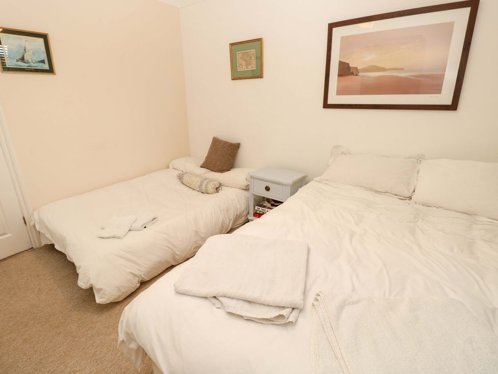A bedroom with two beds and a nightstand at Riverview in Hamble