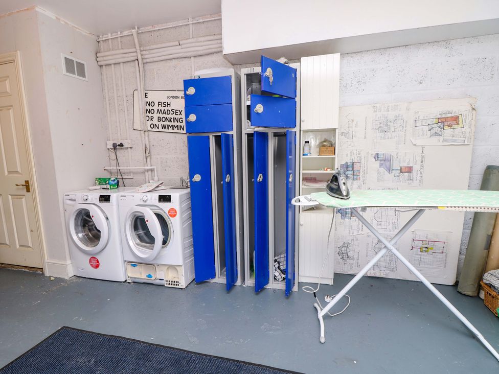 A utility room with laundry appliances and lockers at Riverview in Hamble
