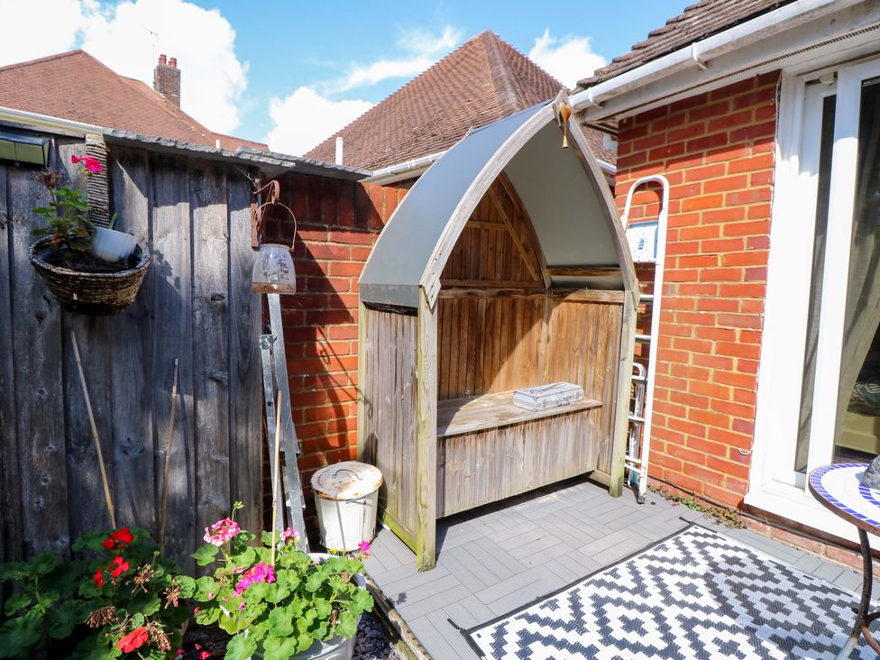 A garden area with a bench and flower pots at Riverview in Hamble
