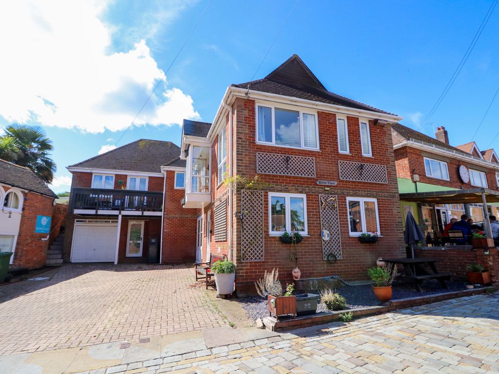 A house with balconies and potted plants at Riverview in Hamble
