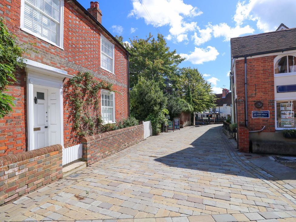 A street view with brick houses and trees at Riverview in Hamble