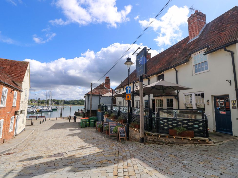 A street with buildings and boats in the marina at Riverview in Hamble
