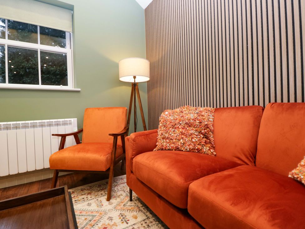 A living room with a sofa and armchair at The Studio in Windermere