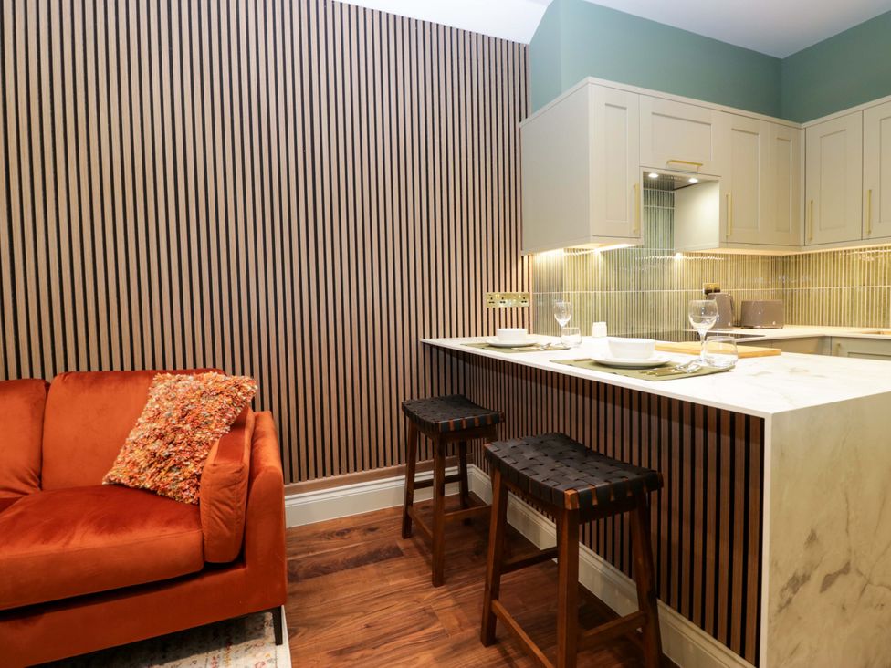 A kitchen with a sofa and countertop at The Studio in Windermere